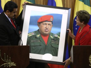 No centro da mesa, a Presidente Dilma Rousseff no 13º Congresso do Partido Comunista do Brasil. A bandeira da foice e martelo escondendo a bandeira do Brasil. Nas extremidades quadros de Marx e Lenin...